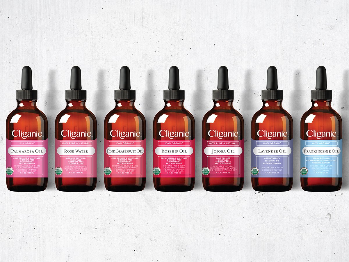 Cliganic essential oil bottles including Palmarosa, Rose Water, Pink Grapefruit, and Lavender