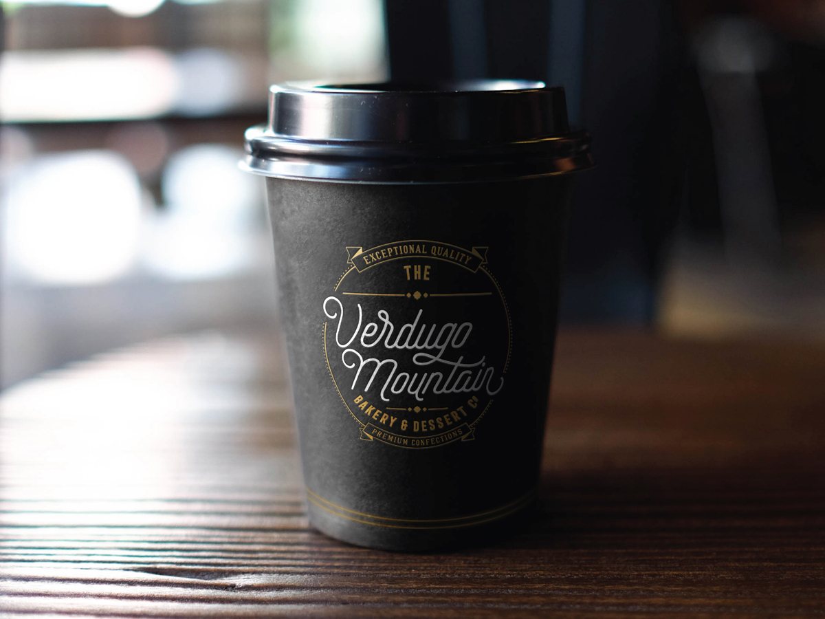 The Verdugo Mountain Bakery branded coffee cup